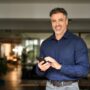 Happy,Middle,Aged,Older,Male,Investor,Holding,Mobile,Phone,Looking